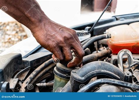 Black Man As Auto Mechanic Working in Garage Near Car Engine. Repair Service and Transport ...