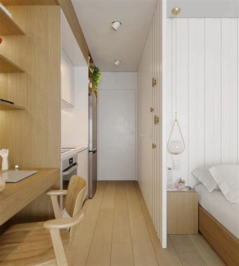 a bedroom with wood flooring and white walls, along with a bed in the ...