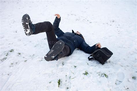 A man falls in the snow. The man slipped and was injured. Falling on ice. Winter. Fracture ...