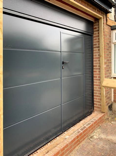 A hormann lpu42 l ribbed sectional garage door wicket door finished in ...