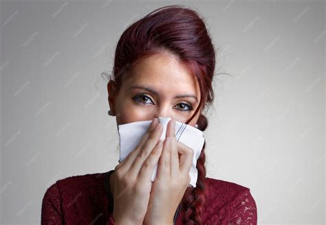 Premium Photo | Studio portrait of a beautiful girl blowing her nose