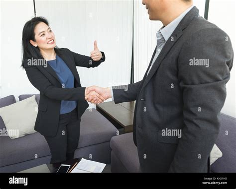 Smile Business woman and business man shaking hand and thumb up in ...