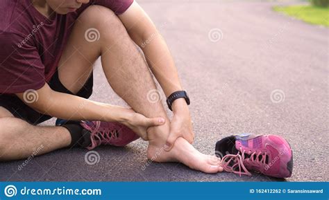 Ankle Sprained. Young Man Suffering From An Ankle Injury While Running ...
