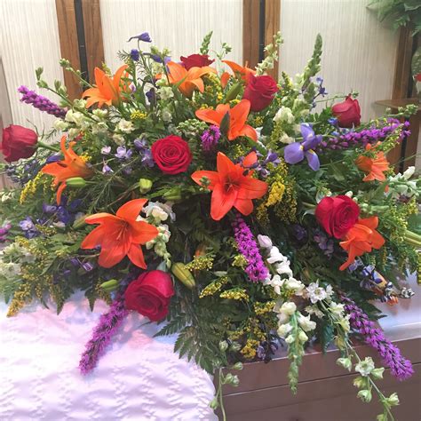Half casket spray with vibrant flowers | Casket flowers, Funeral floral ...
