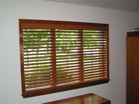 Stained wood blinds on a large window. | Wooden blinds, Wood window ...