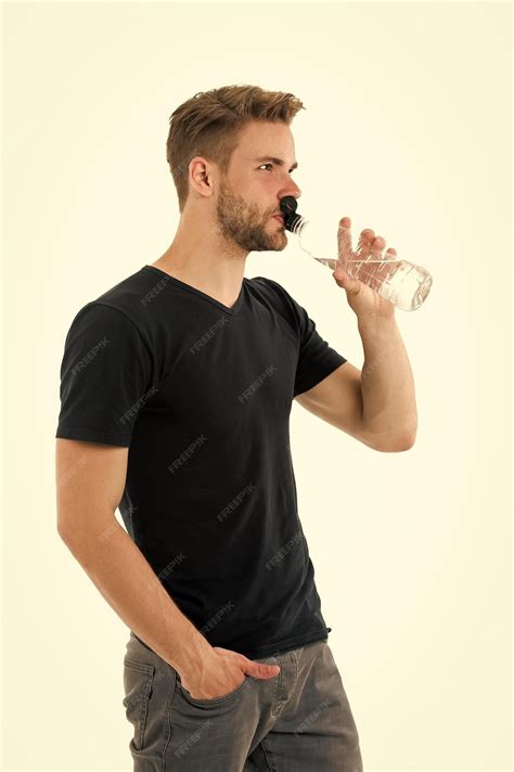 Premium Photo | Feeling thirsty Man athlete hold water bottle Guy drink ...