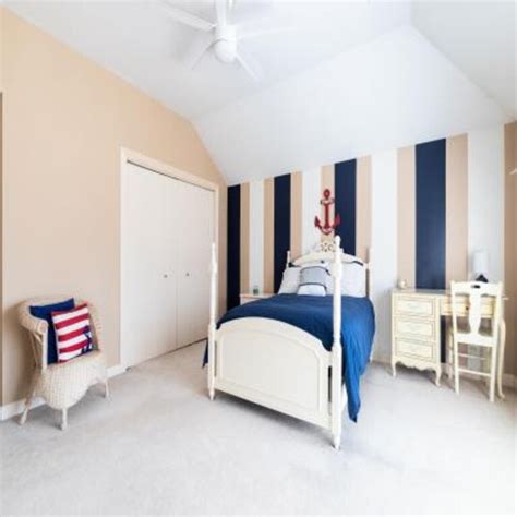 Minimal Beige Kids Room Design With 3-Door Off-White Wardrobe