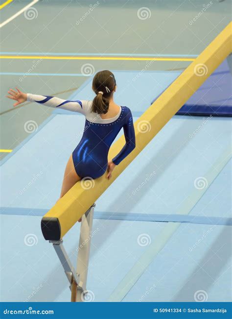 Young Gymnast Girl Performing Routine on Balance Beam Stock Photo ...
