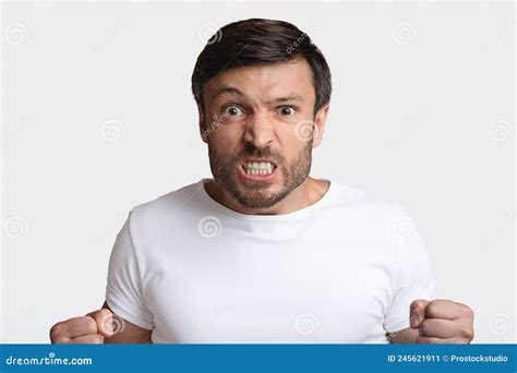 Furious Man Clenching Fists in Rage on White Studio Background Stock ...