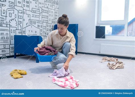 Housewife Collecting Scattered Clothes into the Wash Bowl Stock Photo ...