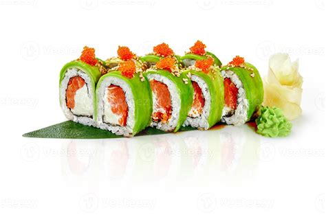 Green sushi roll with avocado, salmon and tobiko on bamboo leaf ...