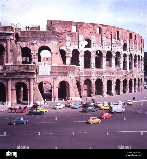 1960s, historical, Rome, Italy and cars parked outside the giant ...