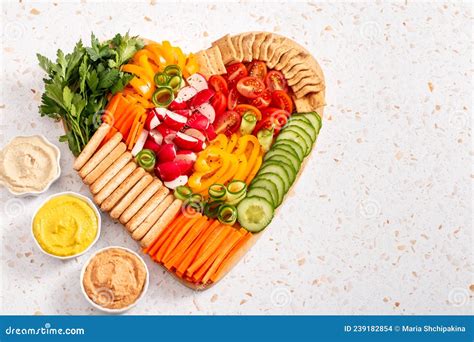 Colorful Vegan Charcuterie Board with Raw Vegetables and Whole Wheat ...