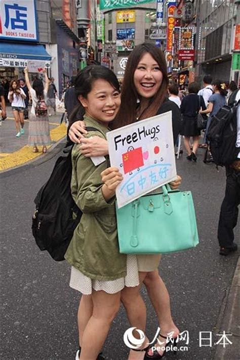 Chinese and Japanese Youth Embrace in Tokyo - People