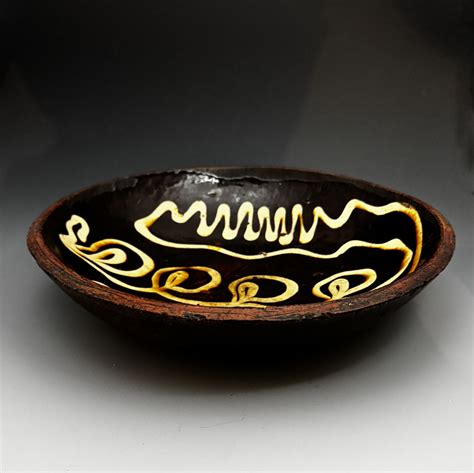 English earthenware slipware circular baking or loaf dish with a elaborate trailing slip pattern ...