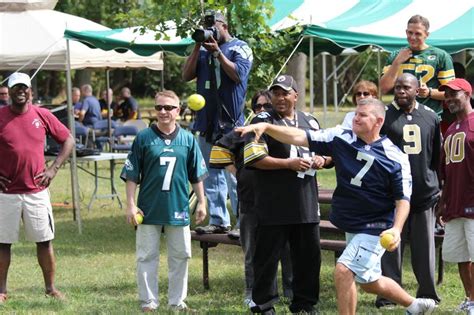 Staff taking turns trying to dunk MG M Ted Wong in the dunk tank during ...