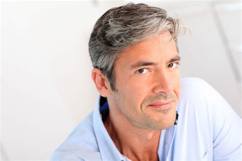Handsome 40-year-old man sitting in armchair at home Stock Photo - Alamy