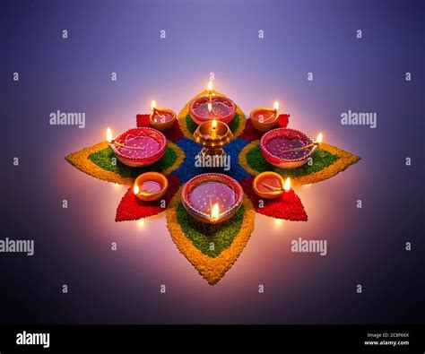 Happy Diwali, diya lamps lit on colorful rangoli Stock Photo - Alamy