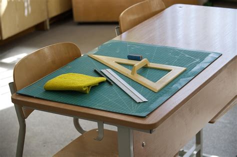 Classroom desk with math tools ruler and eraser on a cutting mat ...