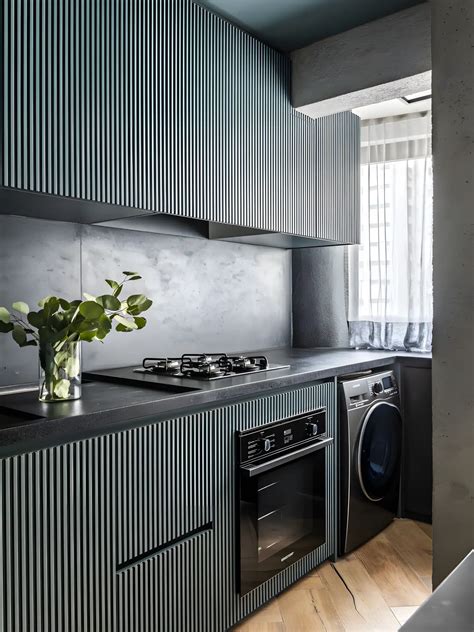 Compact Modern Kitchen with Fluted Cabinetry and Dark Tones