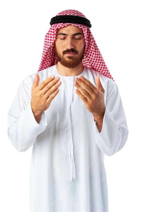 Premium Photo | Young Arab man in traditional clothing praying on white ...