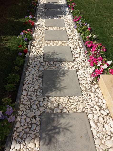 Cement block tiles bordered by white pebbles for a simple pathway ...