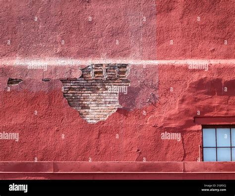 Building shedding stucco over brick Stock Photo - Alamy