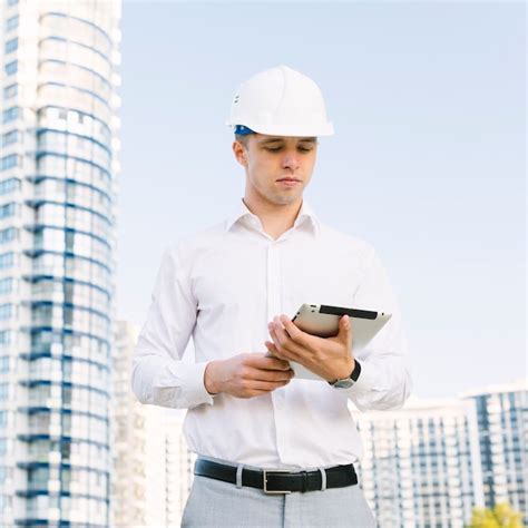 Medium shot man looking at tablet | Free Photo