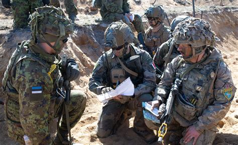 Royal Air Force ground crew preparing an RAF Typhoon fighter jet. It is night-time and the team are