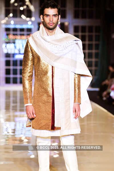 A model showcases a creation by designer Manish Malhotra on Day 3 of ...