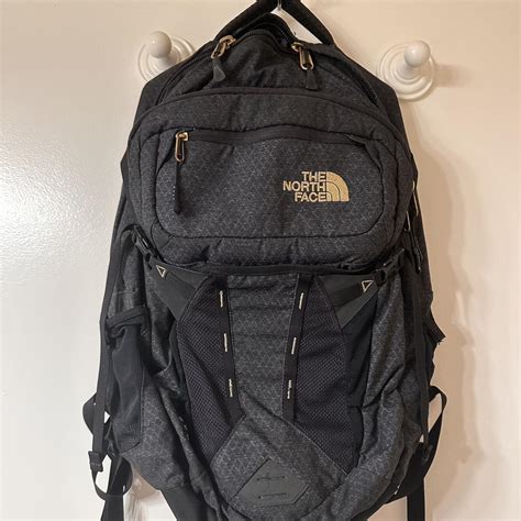 Black and gold North Face Backpack #Northface... - Depop