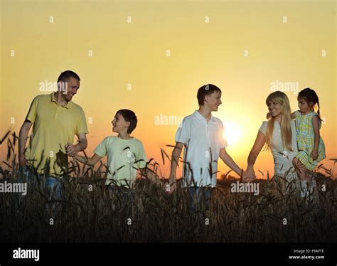 Happy family in wheat field Stock Photo - Alamy