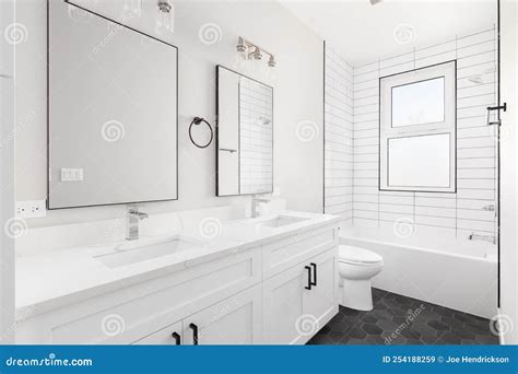 A White Bathroom with a Hexagon Floor and Subway Tile Shower. Stock ...