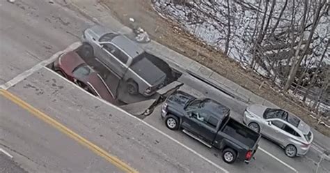 Watch: Sinkhole swallows two vehicles at Omaha intersection | FOX 13 ...