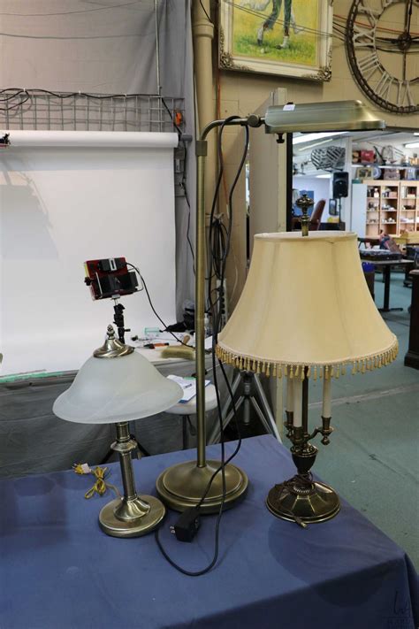 Two non-matching brass table lamps and a floor standing Verilux floor ...