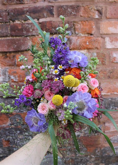 wild and wonderful bridal bouquet of mixed garden style flowers , an ...