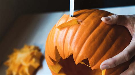 Download Pumpkin Carving With Knife Pictures 2120 x 1192 | Wallpapers.com