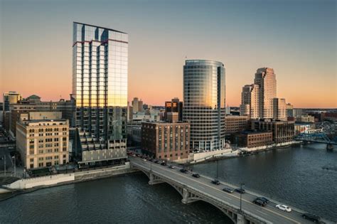 City skyline at sunset featuring modern buildings along a river, representing urban business environments relevant to managed IT services in Pennsylvania.