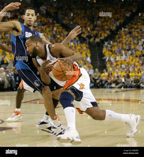 Golden State Warriors' Baron Davis, foreground, drives past Dallas ...