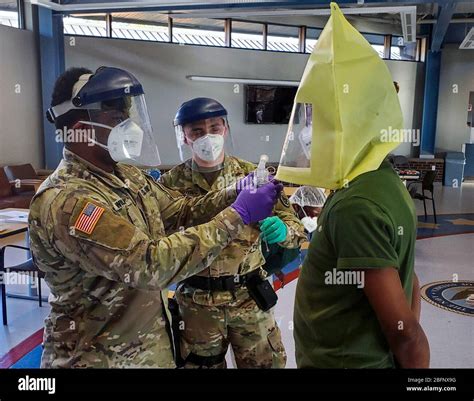New Jersey National Guard soldiers test fit a N95 respirator fit test before conducting COVID-19 ...
