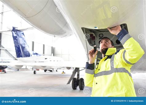 Airport Workers Check an Aircraft for Safety in a Hangar Stock Image ...