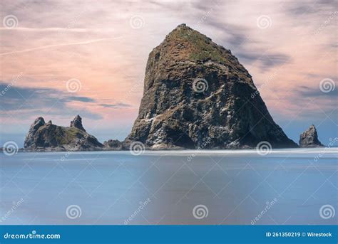 Huge High Rock with Pink Clouds on the Horizon in Cannon Beach, Oregon ...