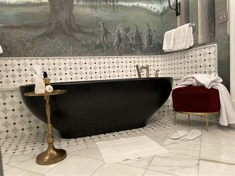 The Ritz-Carlton bath mat hung over standing bathtub