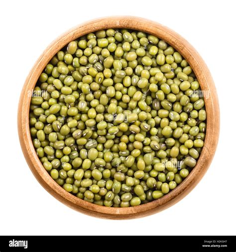 Mung beans in a wooden bowl on white background. Dried beans of Vigna ...