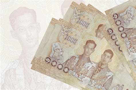 1000 Thai baht bills lies in stack on background of big semi ...