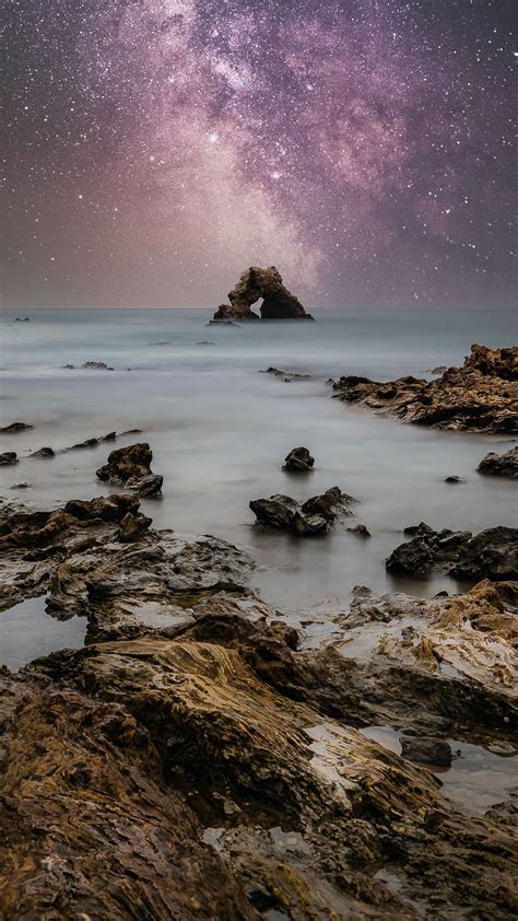 Download wallpaper 1080x1920 sea, coast, rocks, starry sky, water ...