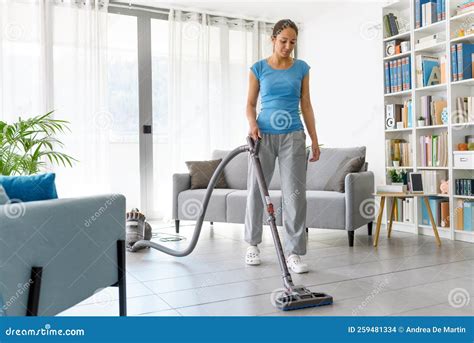 Woman Vacuuming the Floor at Home Stock Photo - Image of holding ...
