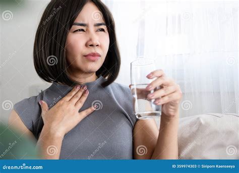Asian Woman Experiencing Sore Throat, Common Cold Symptoms while ...