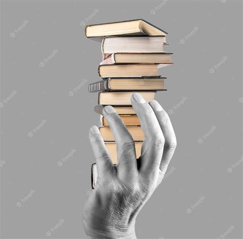 Premium Photo | Hand holding books stack on grey background knowledge ...