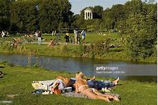 Englischer Garten Fkk sunbathing at eisbach in front of monopteros Englischer Garten Fkk sunbathing at eisbach in front of monopteros
